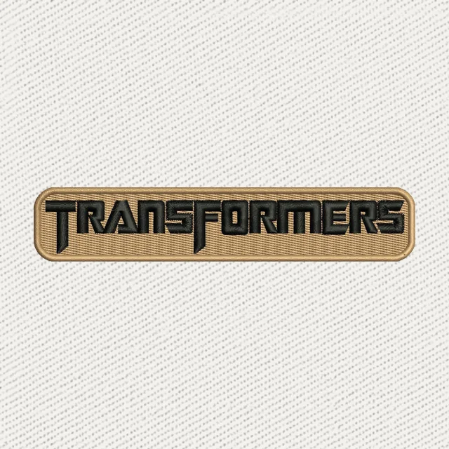 Motif de broderie Nom Transformers noir sur plaque beige